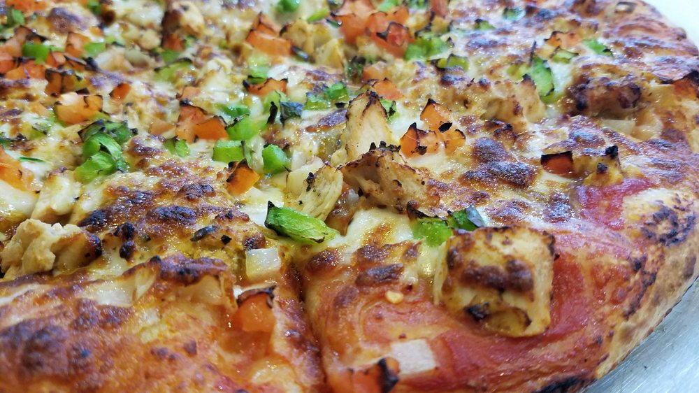Eat unique food in Kent, Washington, such as exceptional flavors at Benson Curry Pizza