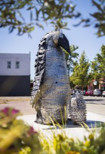 Metallic penguin art made of spoons and forks in downtown Kent, Washington