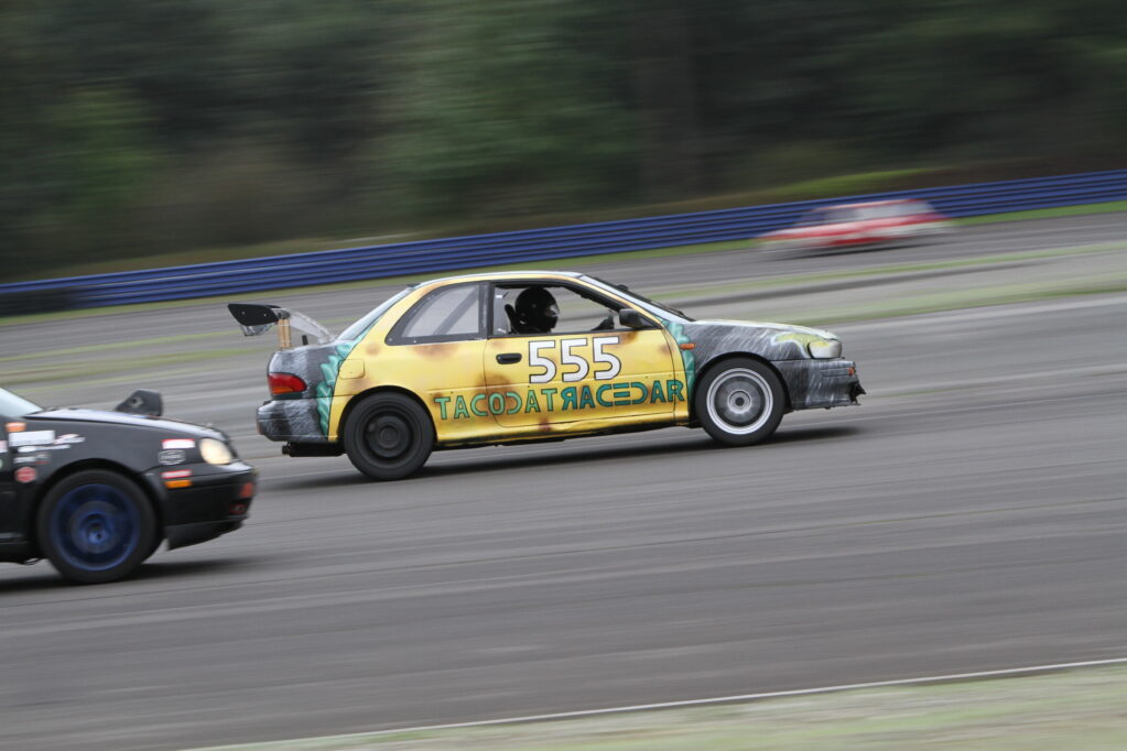 Photo that shows cars racing during 24 hours of Lemons at Pacific Raceways in Kent, WA