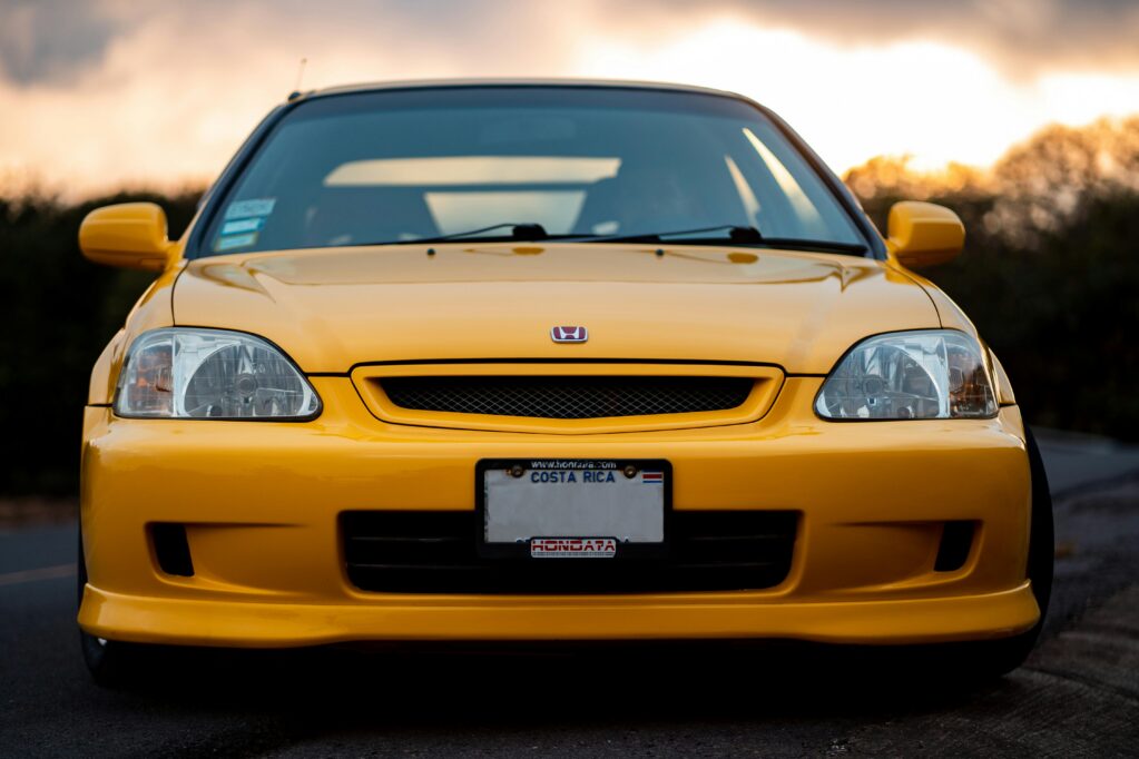 Photo of the front of a late 90s yellow honda civic